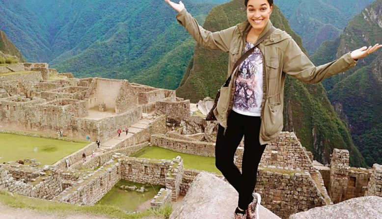 the author Tinabeth Pina in Peru overlooking ruins in the mountains