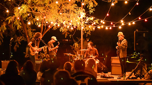 a band playing a small outdoor concert at night