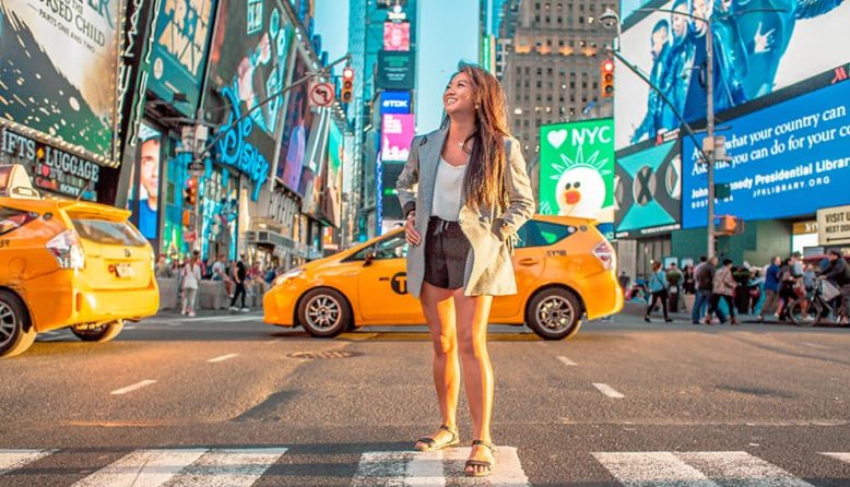 a woman stands in times square in new york city