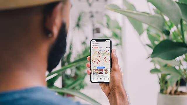 a man looks at a map on an iphone