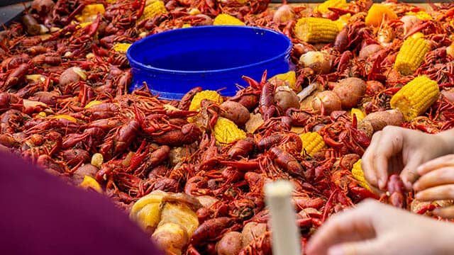 a pile of boiled crawfish with lemons
