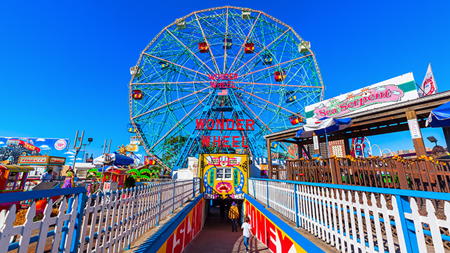 the wonderwheel ferris wheel at Coney Island brooklyn, with a blue sky behind