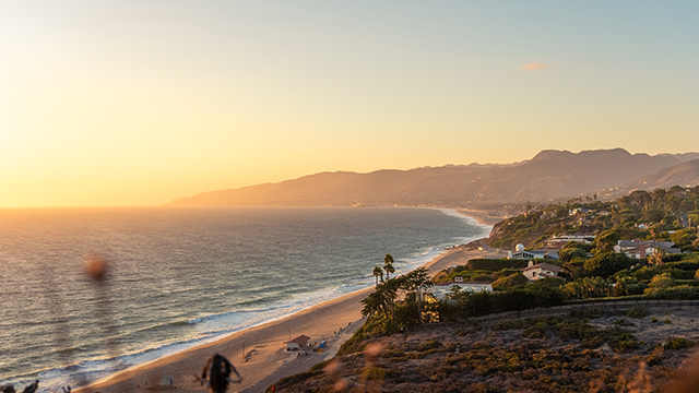 a long beach at sunset