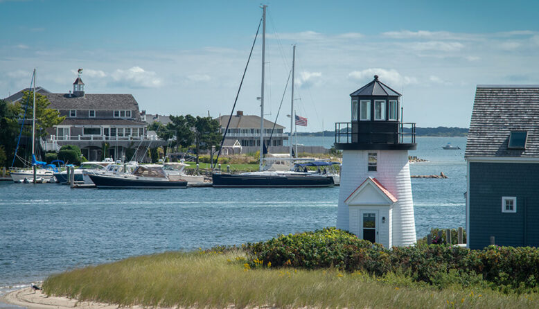 a small white lighthouse in the harbor in Hyannis Massachusetts