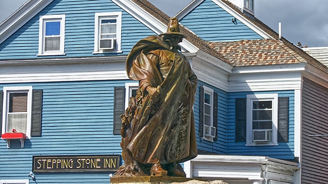 a statue in front of a historic building in salem massachusetts