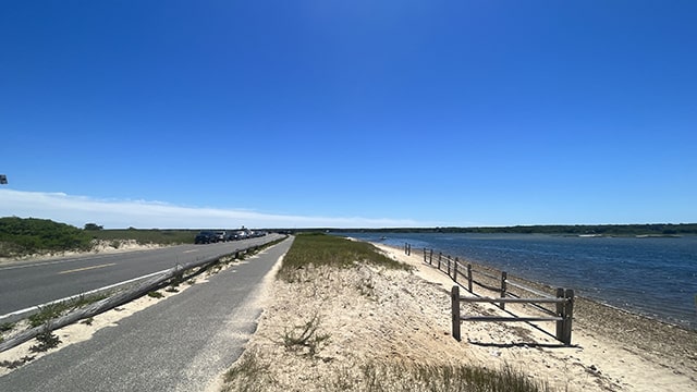 a paved bike path runs along the beach on martha's vineyard
