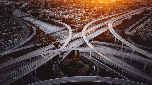multiple interweaving highways seen from above at sunset