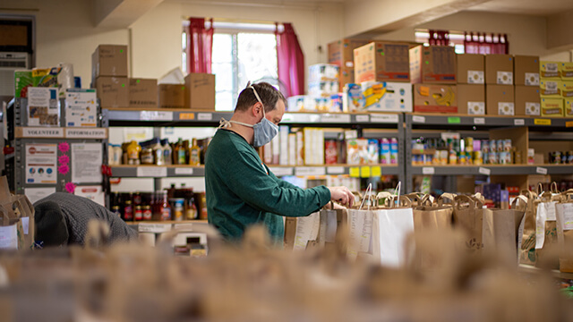 a volunteer sorts donations at a foodbank