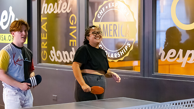 two young people play table tennis