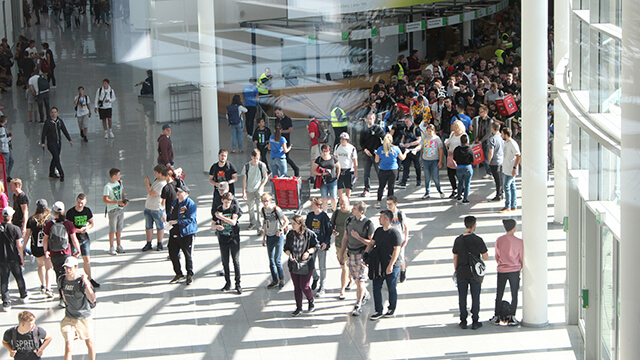 people walk the halls of a convention center