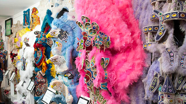 pink and blue headdresses and masks with feathers and beads