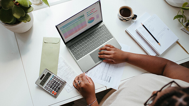 an overhead view of a person working at a laptop