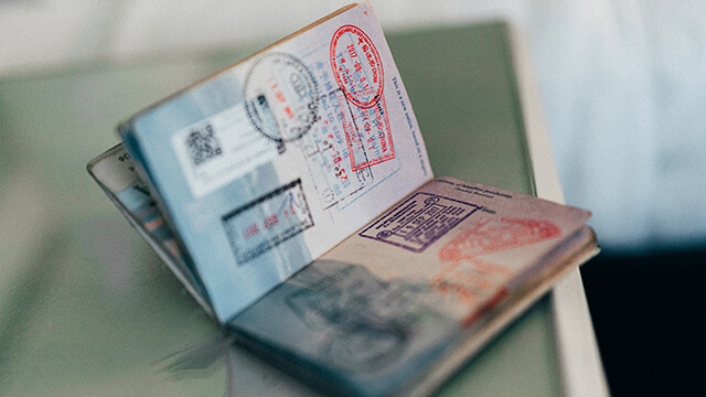 an open passport with stamps on its pages