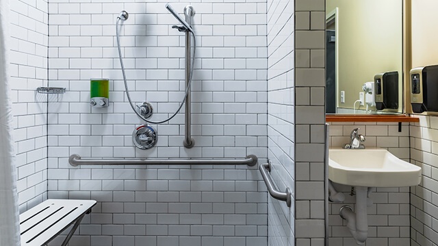 HI USA hostels offer accessible bathrooms with roll-in showers and hand-held shower heads like this one