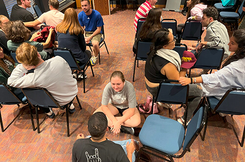 a group of young people from 5 Western and Arab countries sit discussing cultural similarities and differences during Hostelling International's IOU Respect program