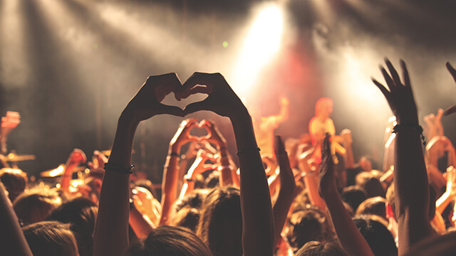 hands raised in the air at a concert