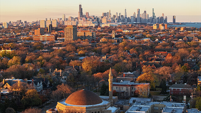 an aerial view of the southside of Chicago in the autumn, with the city skyline in the background
