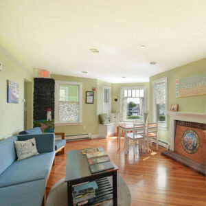 A cozy living room where guests can relax at HI Hyannis hostel on Cape Cod.