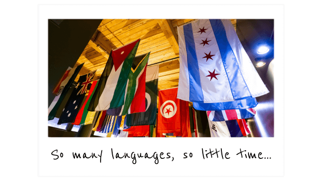 dozens of colorful international flags hanging from the ceiling