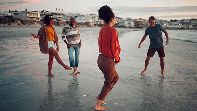 four friends on the beach in Santa Monica at sunset