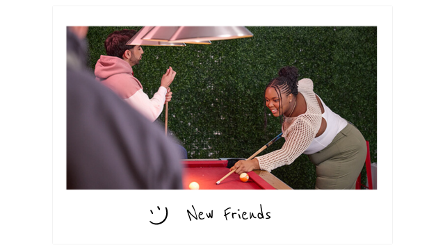 a young woman plays pool on a red pool table while two other young people watch