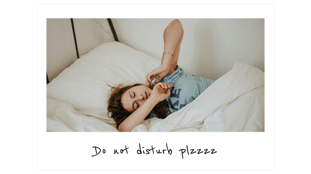 a woman lays in bed under the covers and stretches her arms