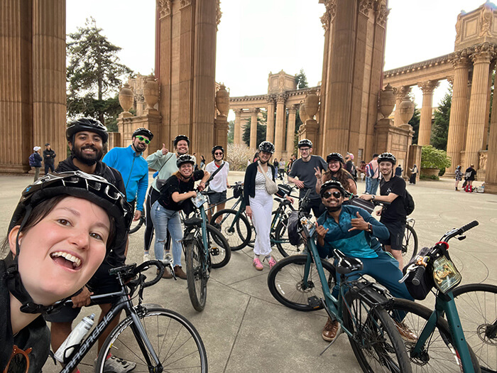 HI San Francisco Downtown Hostel guests pose on their bicycles at the Palace of Fine Arts during a morning city bicylce tour from the hostel