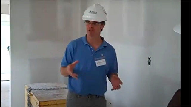 Former HI USA Resource Development staff member John Yonce is shown in a freeze-frame from a video giving a hardhat tour of HI Hyannis hostel when it was under construction before opening in 2011.