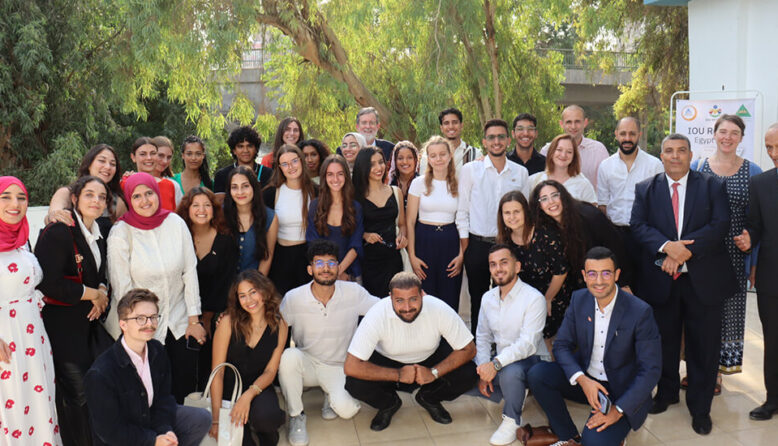 A large group of young people from around the world, participating in HI USA's IOU Respect program in Egypt, pose for a group photo.