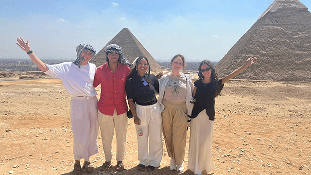HI USA's group of 2025 IOU Respect program participants pose together in front of the Pyramids in Egypt.