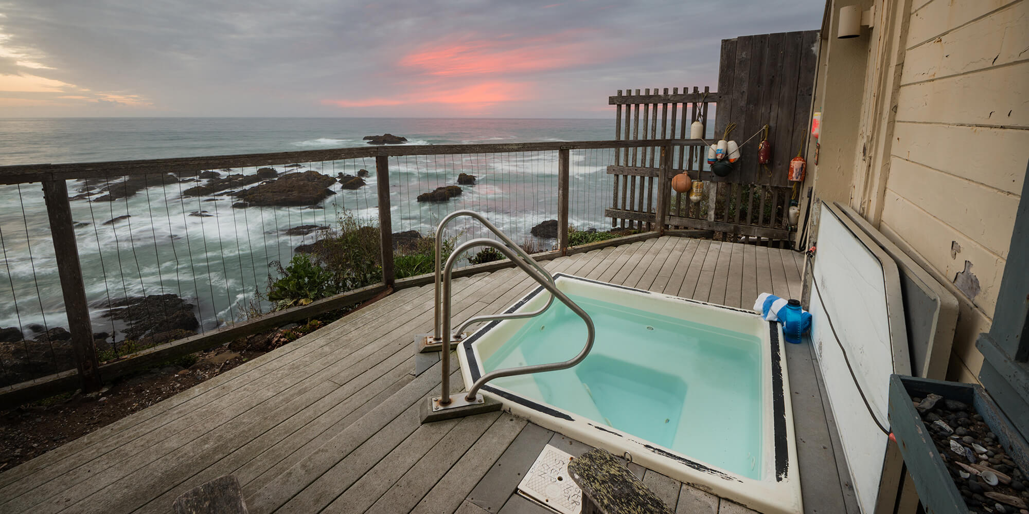 The famous cliffside hot tub at HI Pigeon Point Lighthouse hostel, seen here at sunset, can be reserved by hostel guests after their arrival.