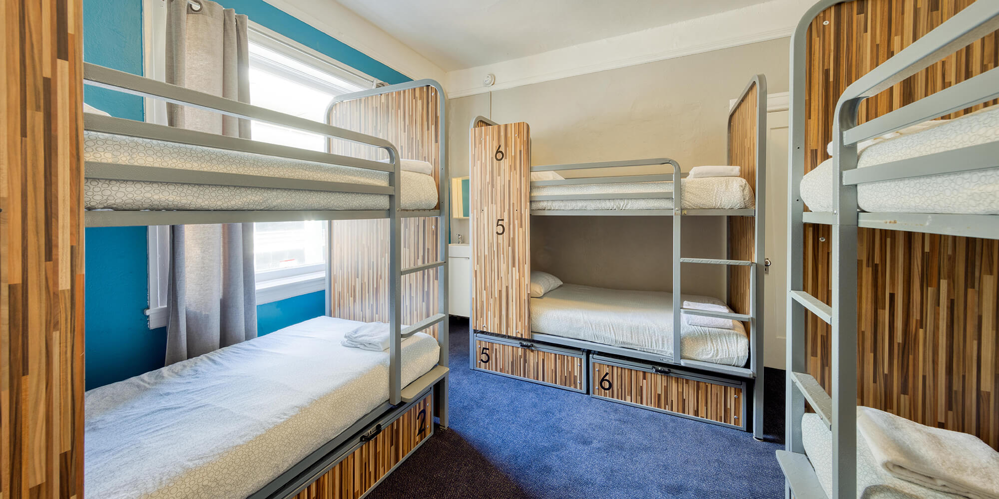 A six-bed dorm room with modern bunks at HI San Francisco Downtown hostel