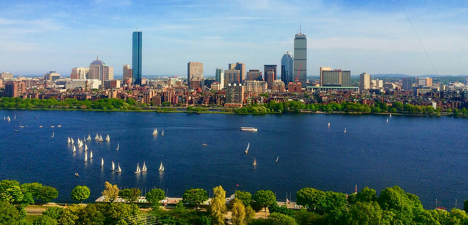 The skyline of Boston as seen from the blue Charles River
