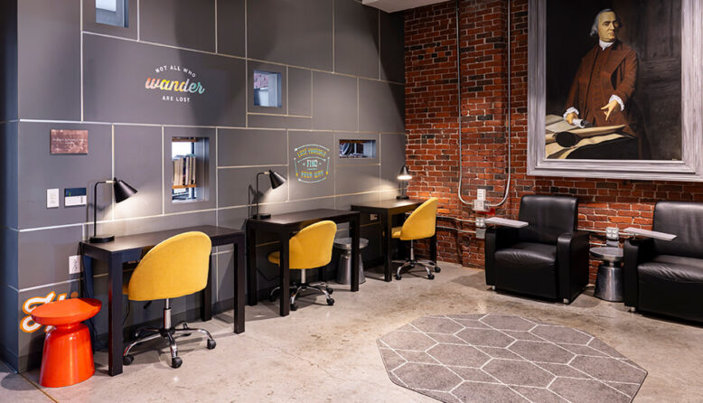 Modern, quiet workstations at HI Boston featuring dedicated desks, ergonomic chairs, and individual task lighting for remote workers.