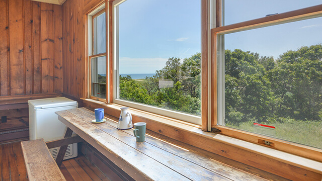 Rustic wooden window counter at HI Truro with views of the Cape Cod National Seashore and the Atlantic Ocean.